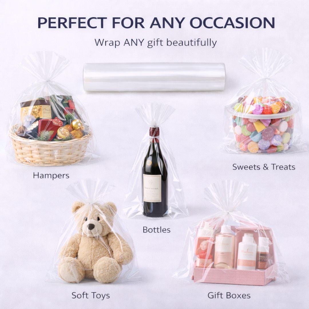 Clear cellophane wrap roll being used to wrap various items including hampers, bottles, soft toys, and gift boxes.