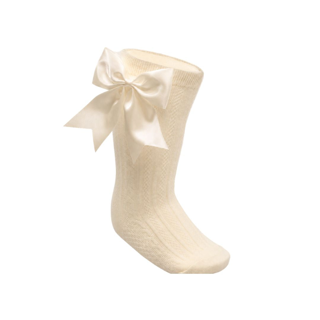 Cream sock with a large bow on.